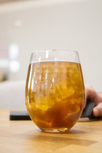 Glas ice tea met hand